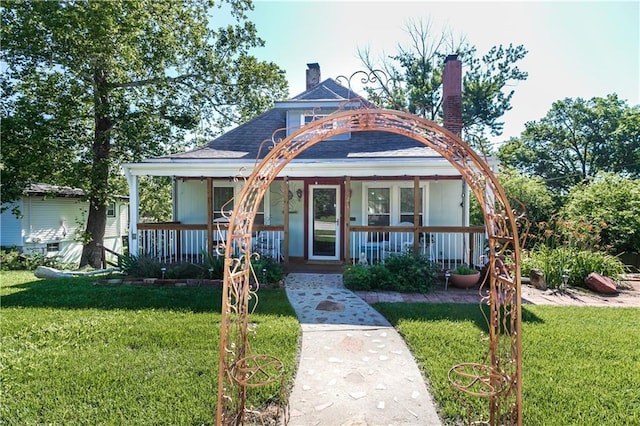 421 N Nettleton Ave, Bonner Springs, KS 66012 - view of front facade featuring a porch, a front yard, and roof with shingles