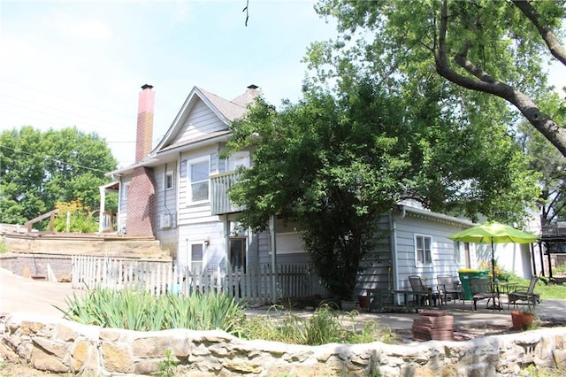421 N Nettleton Ave, Bonner Springs, KS 66012 - view of side of home with a patio and a chimney