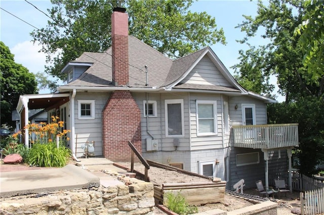 421 N Nettleton Ave, Bonner Springs, KS 66012 - rear view of house with a chimney and a shingled roof
