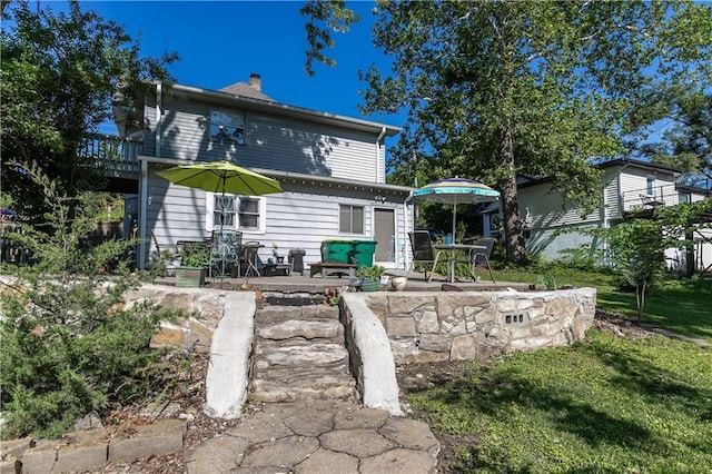 421 N Nettleton Ave, Bonner Springs, KS 66012 - rear view of property featuring a chimney and a patio area