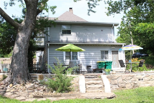 421 N Nettleton Ave, Bonner Springs, KS 66012 - rear view of house featuring a chimney