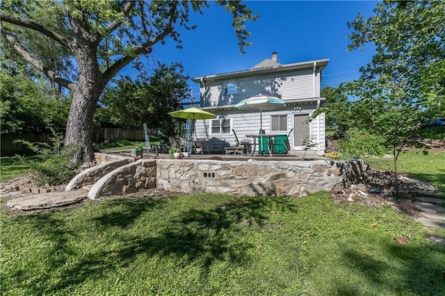 421 N Nettleton Ave, Bonner Springs, KS 66012 - back of property featuring a patio and a chimney