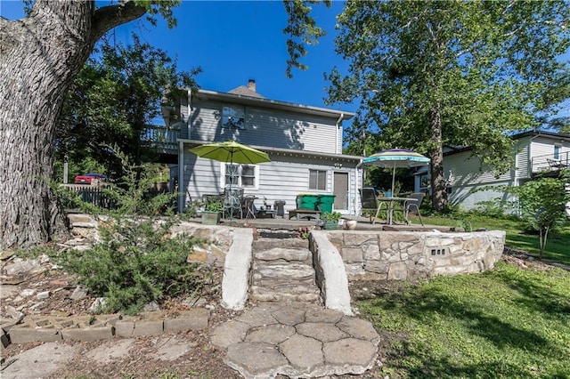 421 N Nettleton Ave, Bonner Springs, KS 66012 - rear view of house with a chimney and a patio