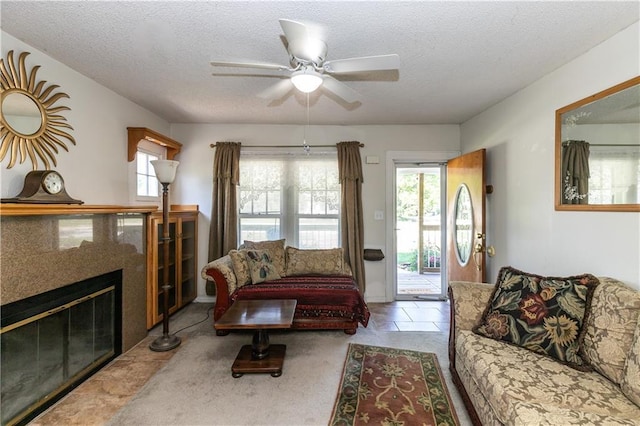 421 N Nettleton Ave, Bonner Springs, KS 66012 - living room featuring healthy amount of natural light, a ceiling fan, a textured ceiling, and a tile fireplace
