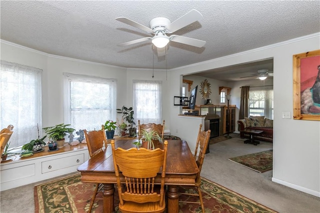 421 N Nettleton Ave, Bonner Springs, KS 66012 - dining room with a ceiling fan, carpet flooring, a textured ceiling, a fireplace, and ornamental molding
