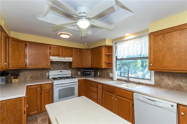 421 N Nettleton Ave, Bonner Springs, KS 66012 - kitchen with white appliances, under cabinet range hood, brown cabinetry, and light countertops