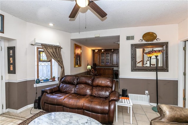 421 N Nettleton Ave, Bonner Springs, KS 66012 - living area with ceiling fan, light tile patterned floors, and a textured ceiling