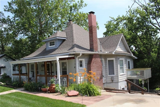 421 N Nettleton Ave, Bonner Springs, KS 66012 - bungalow-style house featuring a porch, a chimney, and roof with shingles