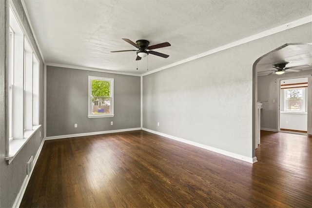 13623 W 95th St, Lenexa, KS 66215 - spare room featuring a ceiling fan, wood finished floors, arched walkways, ornamental molding, and a textured ceiling