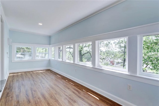 3521 Windsor Ave, Kansas City, MO 64123 - unfurnished sunroom with baseboards and wood finished floors