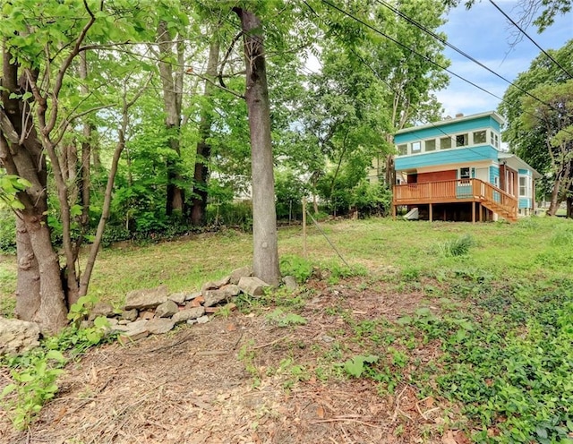 3521 Windsor Ave, Kansas City, MO 64123 - view of grassy yard featuring a wooden deck and stairway