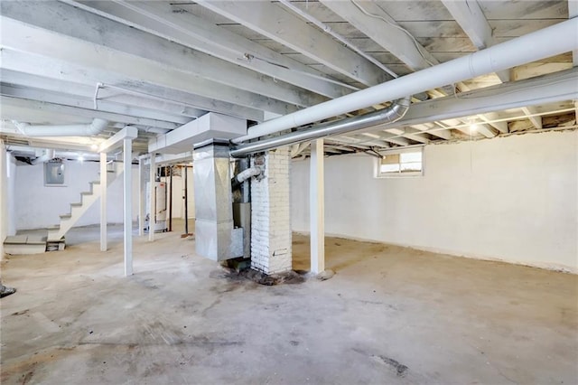 3521 Windsor Ave, Kansas City, MO 64123 - below grade area with stairs, gas water heater, and electric panel