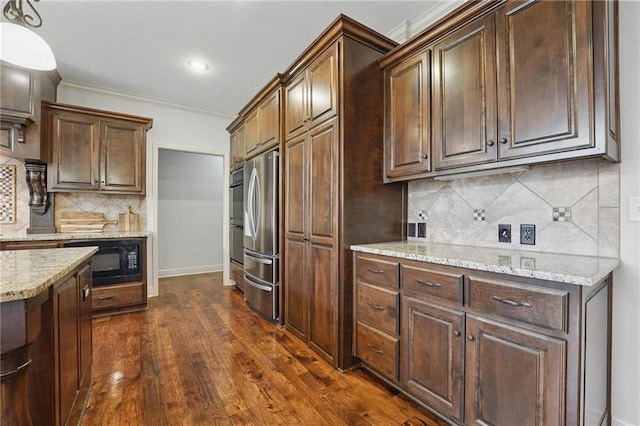 9332 W 158th St, Overland Park, KS 66221 - kitchen featuring black microwave, freestanding refrigerator, light stone counters, dark wood-style flooring, and decorative backsplash