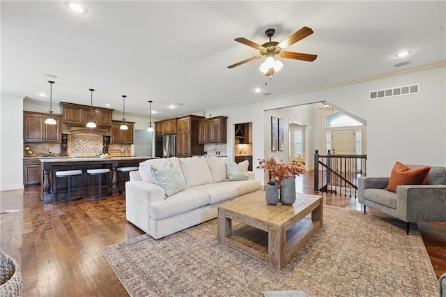 9332 W 158th St, Overland Park, KS 66221 - living area with ornamental molding, dark wood-type flooring, a ceiling fan, and recessed lighting