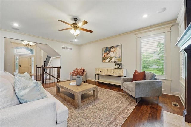 9332 W 158th St, Overland Park, KS 66221 - living room with stairs, wood finished floors, crown molding, a ceiling fan, and a chandelier