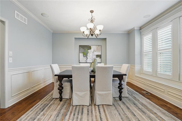 9332 W 158th St, Overland Park, KS 66221 - dining area with wood finished floors, a chandelier, ornamental molding, a wainscoted wall, and a decorative wall