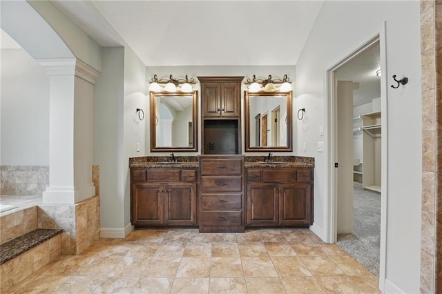 9332 W 158th St, Overland Park, KS 66221 - full bathroom with decorative columns, double vanity, tiled bath, and a walk in closet
