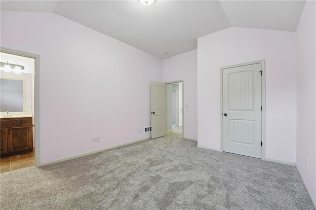 9332 W 158th St, Overland Park, KS 66221 - unfurnished bedroom with vaulted ceiling, carpet, and ensuite bathroom