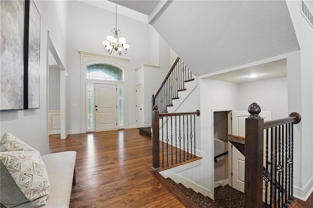 9332 W 158th St, Overland Park, KS 66221 - foyer entrance featuring a chandelier, wood finished floors, and high vaulted ceiling