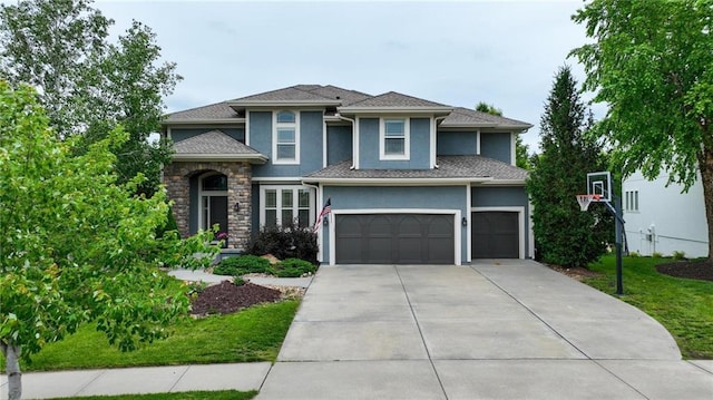 9332 W 158th St, Overland Park, KS 66221 - view of front facade featuring stucco siding, concrete driveway, a garage, and a front yard