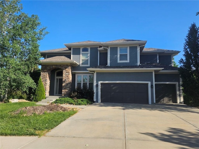 9332 W 158th St, Overland Park, KS 66221 - view of front facade with stucco siding, driveway, and a garage