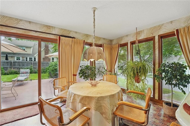 8206 Parkhill Cir, Lenexa, KS 66215 - sunroom / solarium featuring wallpapered walls, a textured ceiling, and brick patterned flooring
