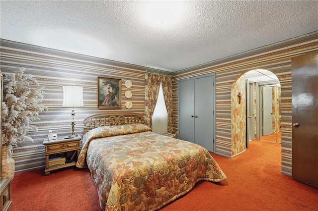 8206 Parkhill Cir, Lenexa, KS 66215 - bedroom with wallpapered walls, carpet flooring, crown molding, a closet, and a textured ceiling