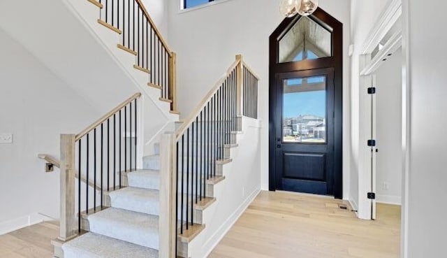 22076 W 99th Ter, Lenexa, KS 66220 - foyer featuring a high ceiling, light wood finished floors, stairway, and baseboards