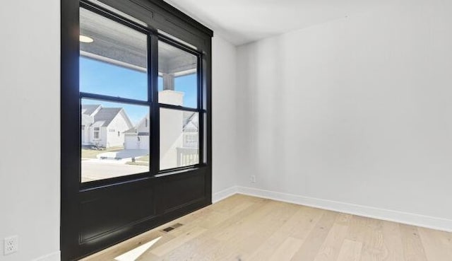 22076 W 99th Ter, Lenexa, KS 66220 - spare room featuring baseboards and wood finished floors