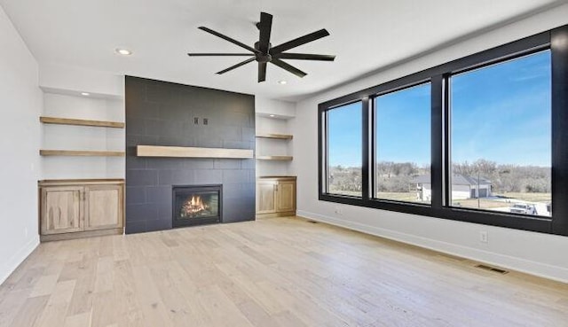 22076 W 99th Ter, Lenexa, KS 66220 - unfurnished living room with wood finished floors, ceiling fan, baseboards, and recessed lighting