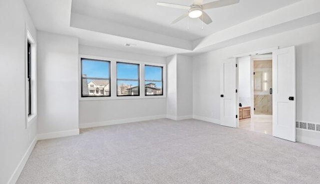 22076 W 99th Ter, Lenexa, KS 66220 - spare room with light colored carpet, a raised ceiling, baseboards, and a ceiling fan