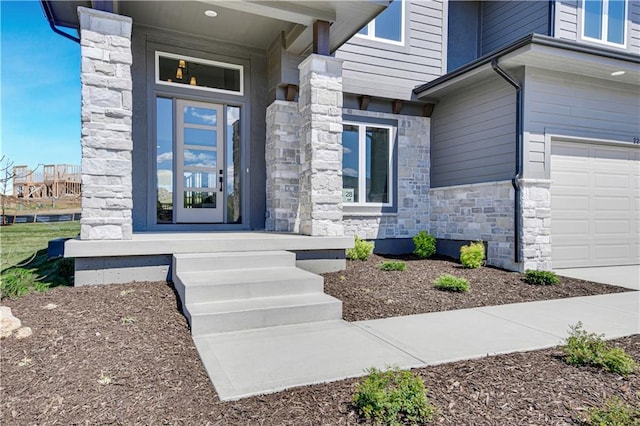21901 W 99th Ter, Lenexa, KS 66220 - doorway to property with stone siding and an attached garage