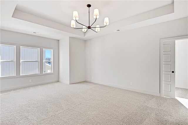 21901 W 99th Ter, Lenexa, KS 66220 - unfurnished room featuring a chandelier, carpet, baseboards, and a raised ceiling