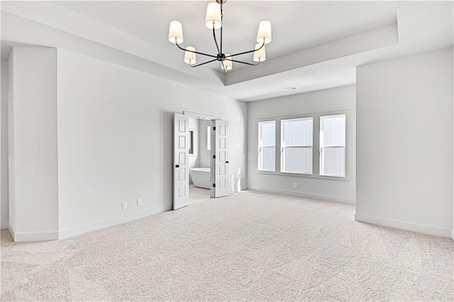 21901 W 99th Ter, Lenexa, KS 66220 - carpeted spare room with a chandelier, baseboards, and a raised ceiling