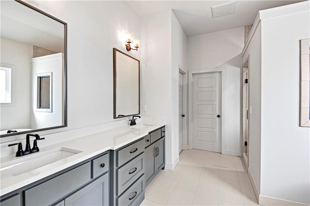 21901 W 99th Ter, Lenexa, KS 66220 - bathroom with double vanity, baseboards, and tile patterned flooring