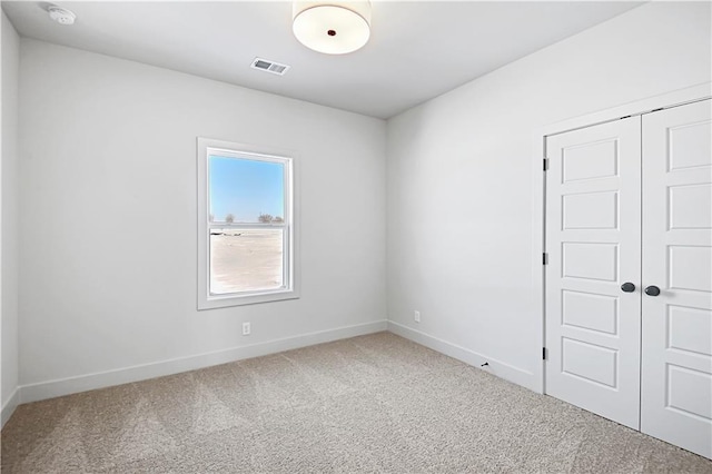 21901 W 99th Ter, Lenexa, KS 66220 - spare room with carpet, a smoke detector, and baseboards