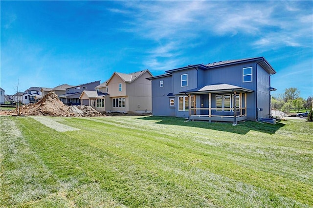21901 W 99th Ter, Lenexa, KS 66220 - rear view of property with a residential view, a yard, and a sunroom