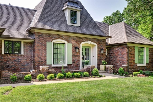 8311 Wenonga Rd, Leawood, KS 66206 - view of front of house with brick siding, roof with shingles, and a front lawn