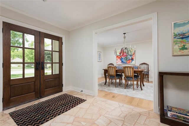8311 Wenonga Rd, Leawood, KS 66206 - foyer entrance featuring a chandelier, french doors, ornamental molding, and light wood-style floors