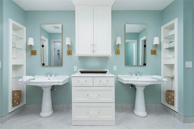 8311 Wenonga Rd, Leawood, KS 66206 - full bathroom featuring two sinks and baseboards
