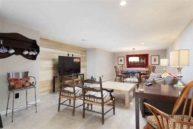 8311 Wenonga Rd, Leawood, KS 66206 - living area with wooden walls, finished concrete floors, recessed lighting, and an accent wall