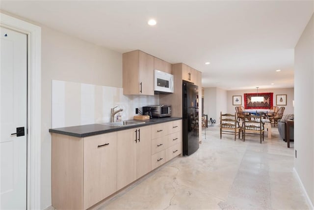8311 Wenonga Rd, Leawood, KS 66206 - kitchen featuring white microwave, light brown cabinetry, freestanding refrigerator, dark countertops, and finished concrete floors