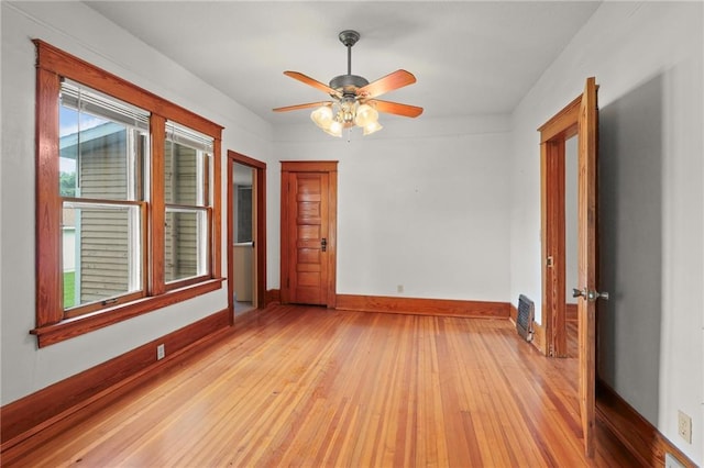 800 Brown Ave, Osawatomie, KS 66064 - spare room with light wood-type flooring, a ceiling fan, and baseboards
