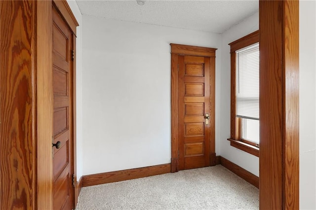 800 Brown Ave, Osawatomie, KS 66064 - unfurnished room with baseboards, light carpet, and a textured ceiling