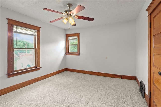 800 Brown Ave, Osawatomie, KS 66064 - unfurnished room featuring carpet floors, baseboards, ceiling fan, and a textured ceiling