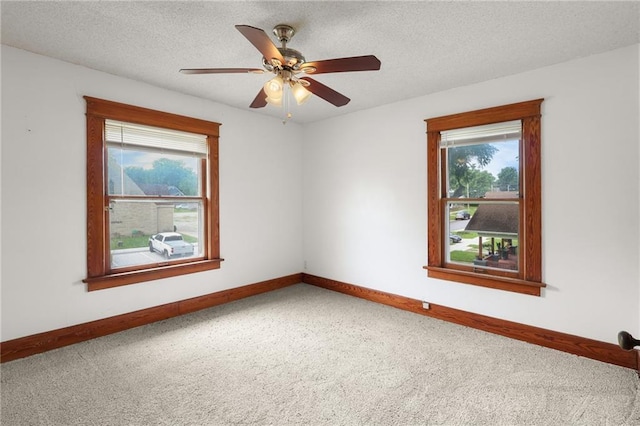 800 Brown Ave, Osawatomie, KS 66064 - carpeted empty room featuring baseboards, ceiling fan, and a textured ceiling