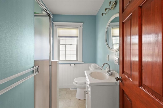 800 Brown Ave, Osawatomie, KS 66064 - bathroom featuring a wainscoted wall, toilet, and vanity