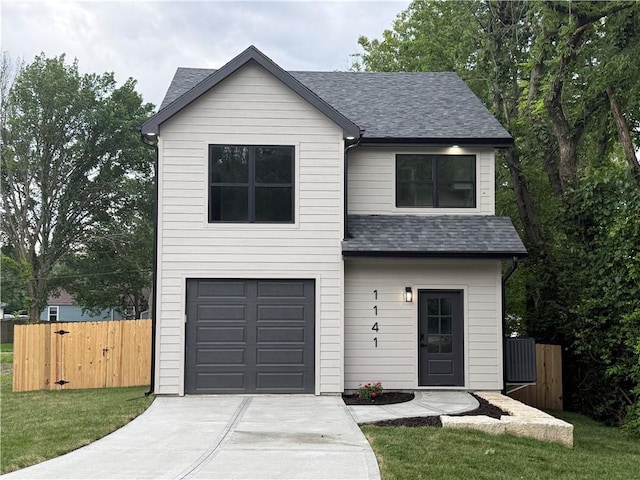 1141 Walnut Ave, Osawatomie, KS 66064 - view of front of home featuring a shingled roof, an attached garage, driveway, and a gate