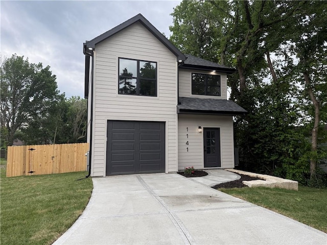 1141 Walnut Ave, Osawatomie, KS 66064 - contemporary home with driveway, a shingled roof, and a garage