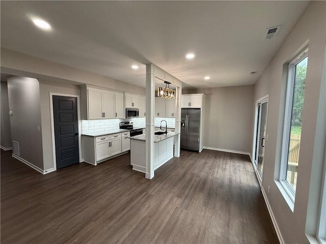 1141 Walnut Ave, Osawatomie, KS 66064 - kitchen with stainless steel appliances, a sink, healthy amount of natural light, dark wood-style flooring, and recessed lighting